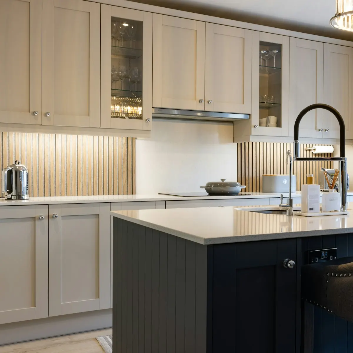 Two-tone kitchen cabinetry with a dark island