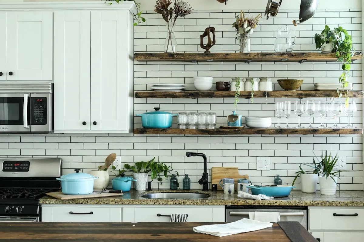 White kitchen with open shelving above the sink
