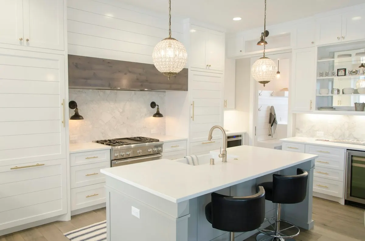 White kitchen island with sink and seating