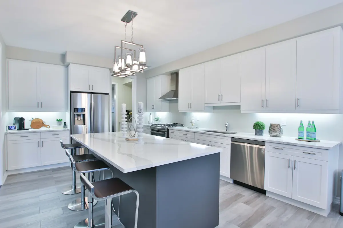 Bright white kitchen with an island and dark seating