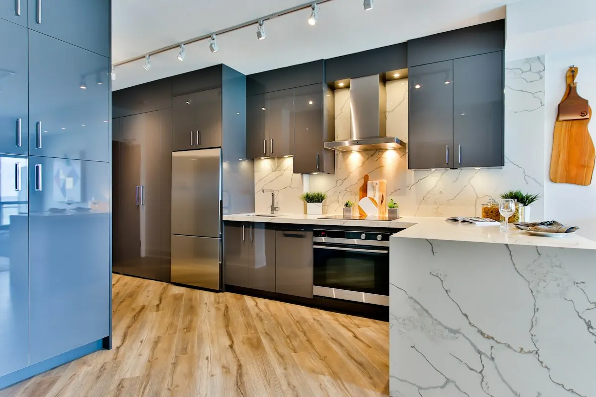 Dark kitchen cabinets with integrated appliances and under-cabinet lighting
