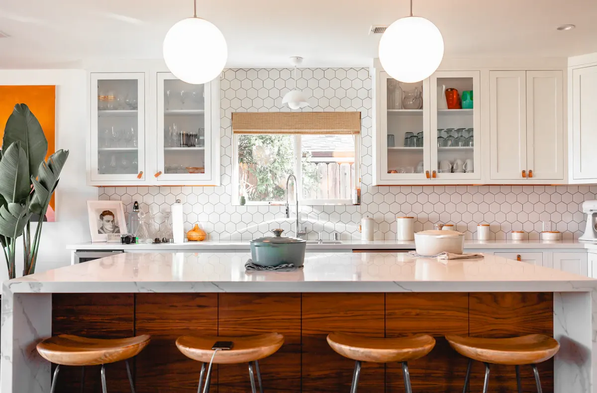 Kitchen island with timber drawers and round pendant lights