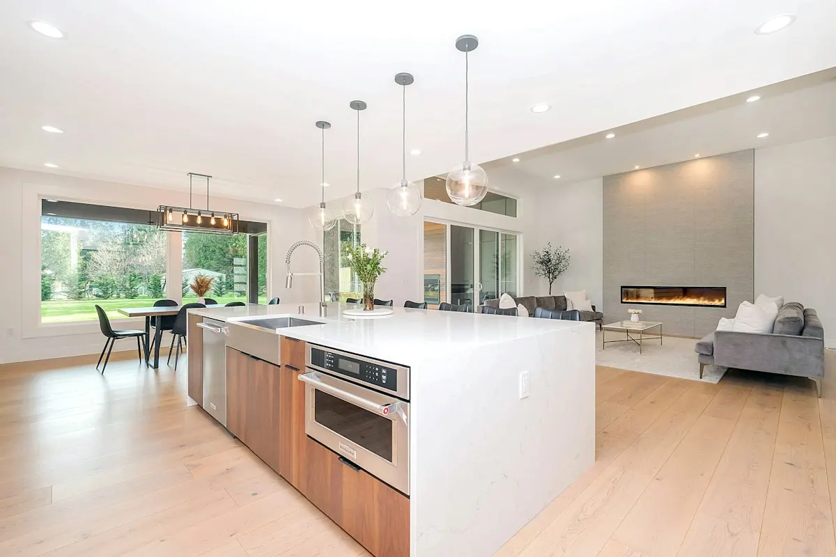 Open-plan kitchen island adjoining a bright living area
