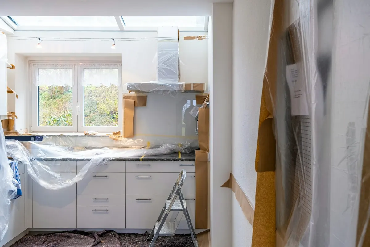 Kitchen protected with plastic sheeting during renovation
