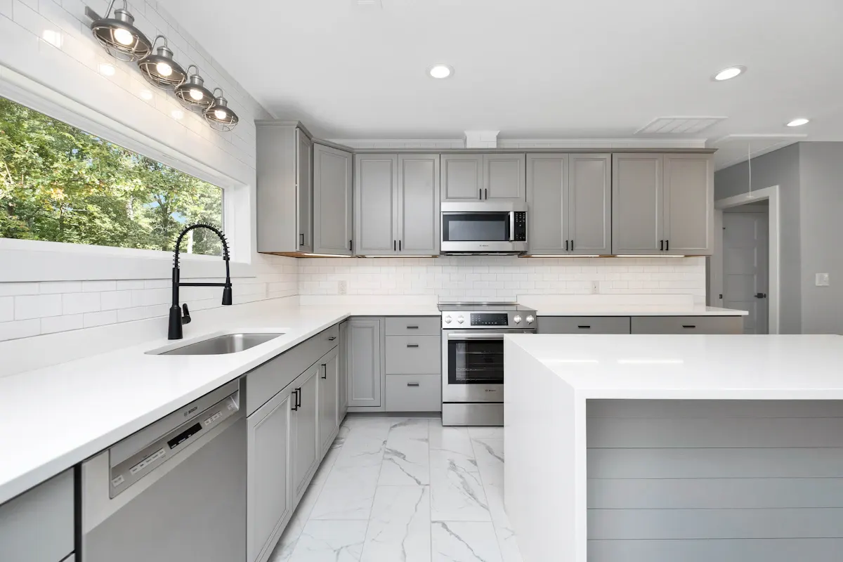 Grey kitchen with pale worktops and overhead task lighting