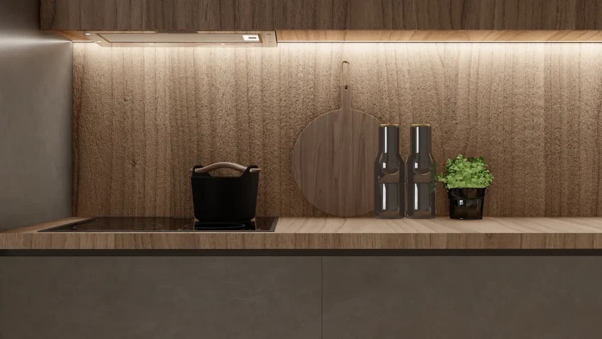 Close view of under-cabinet lighting above a dark kitchen worktop